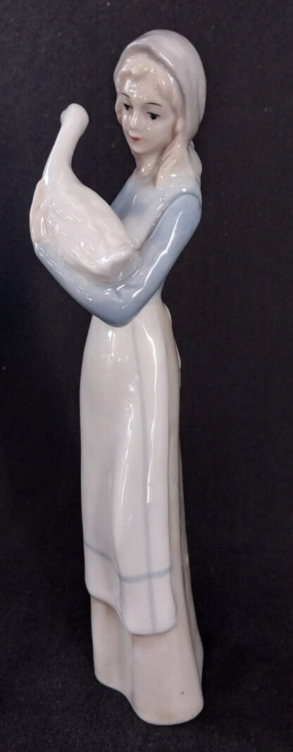 Girl holding a duck, in the, style of, NAO Lladro