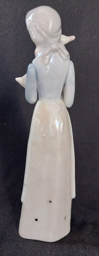 Girl holding a duck, in the, style of, NAO Lladro