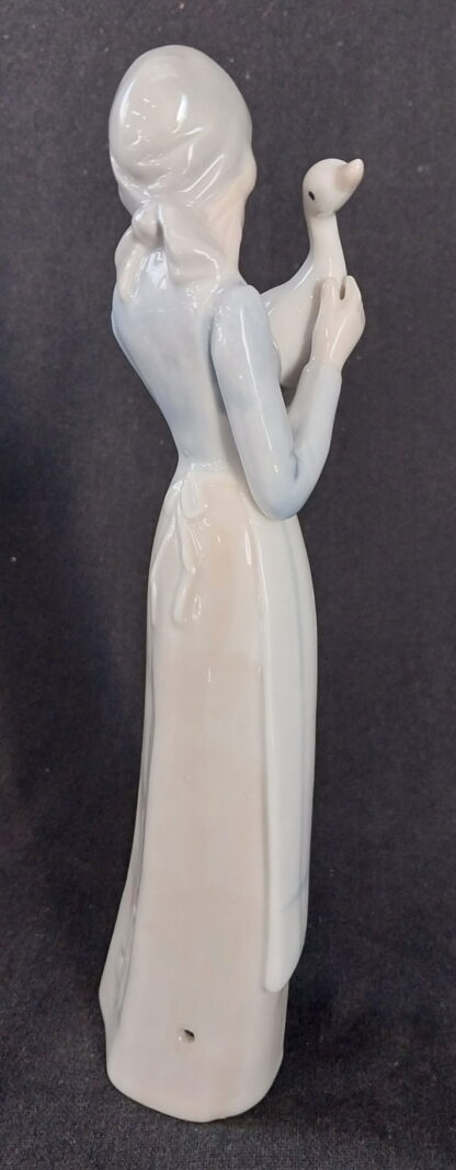 Girl holding a duck, in the, style of, NAO Lladro